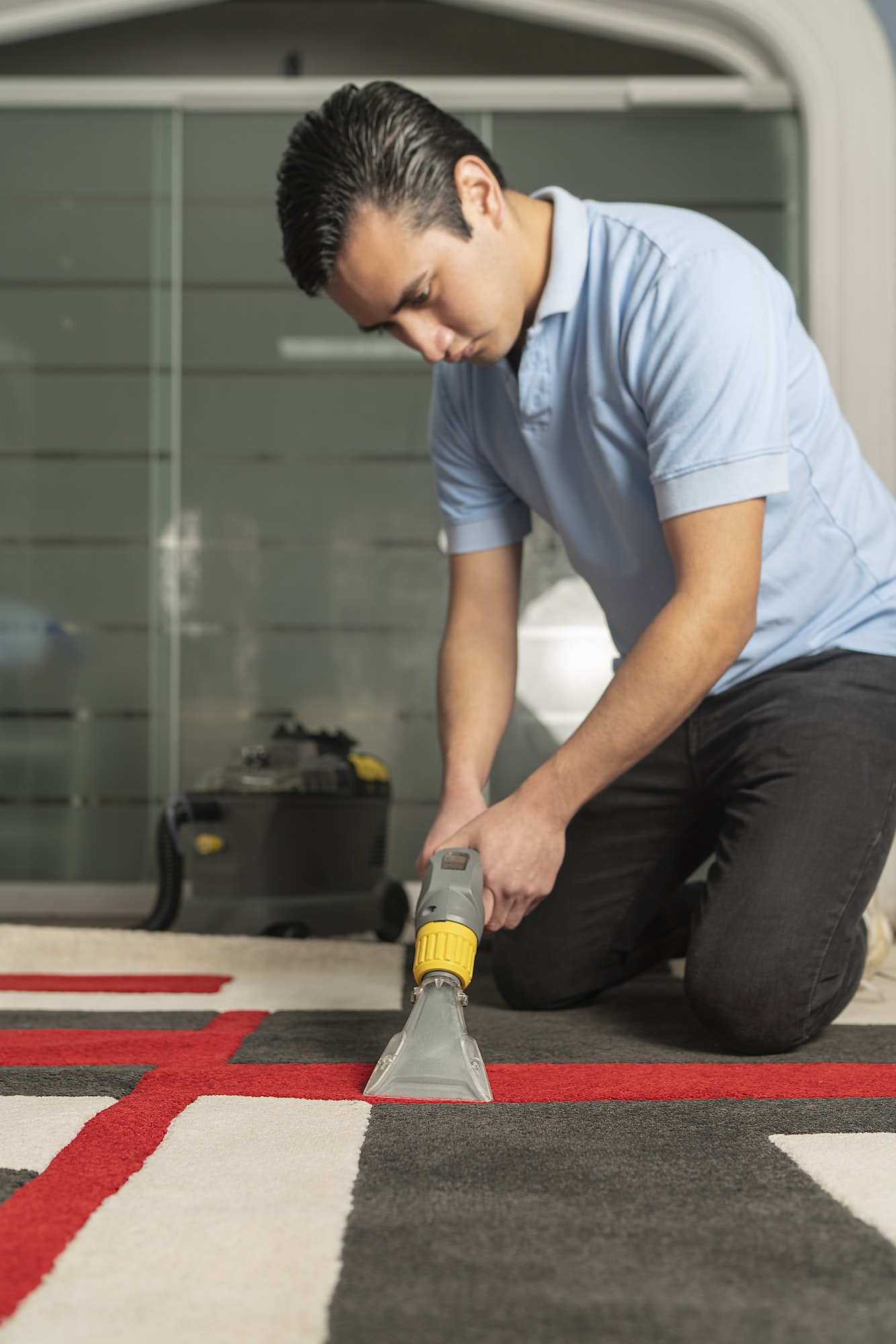 Laundry personnel cleaning carpet with special equipment