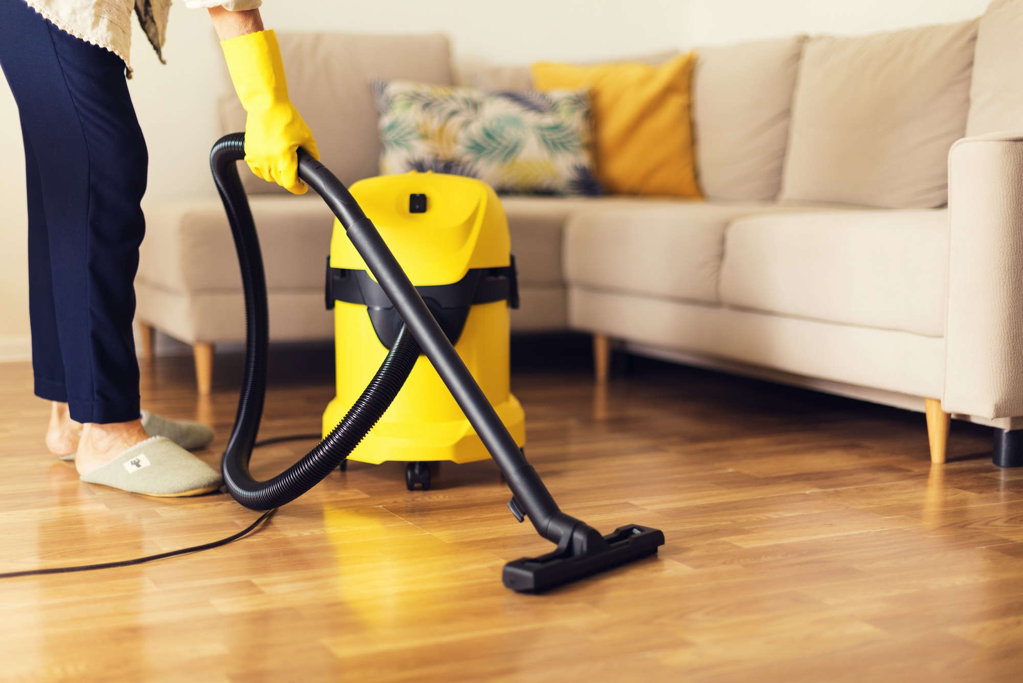 woman-cleaning-sofa-with-yellow-vacuum-cleaner-copy-space-cleaning-service-concept.jpg
